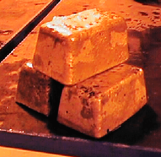 Gold Bullion just extracted from mold