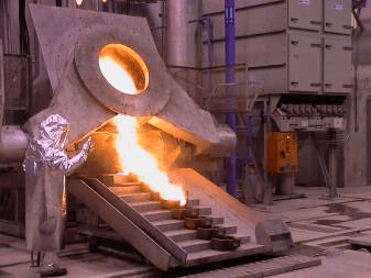 Pouring molten charge into molds