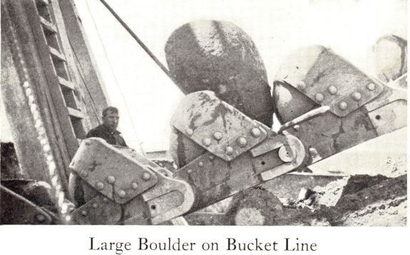 gold-dredge-large-boulder-on-bucket-line